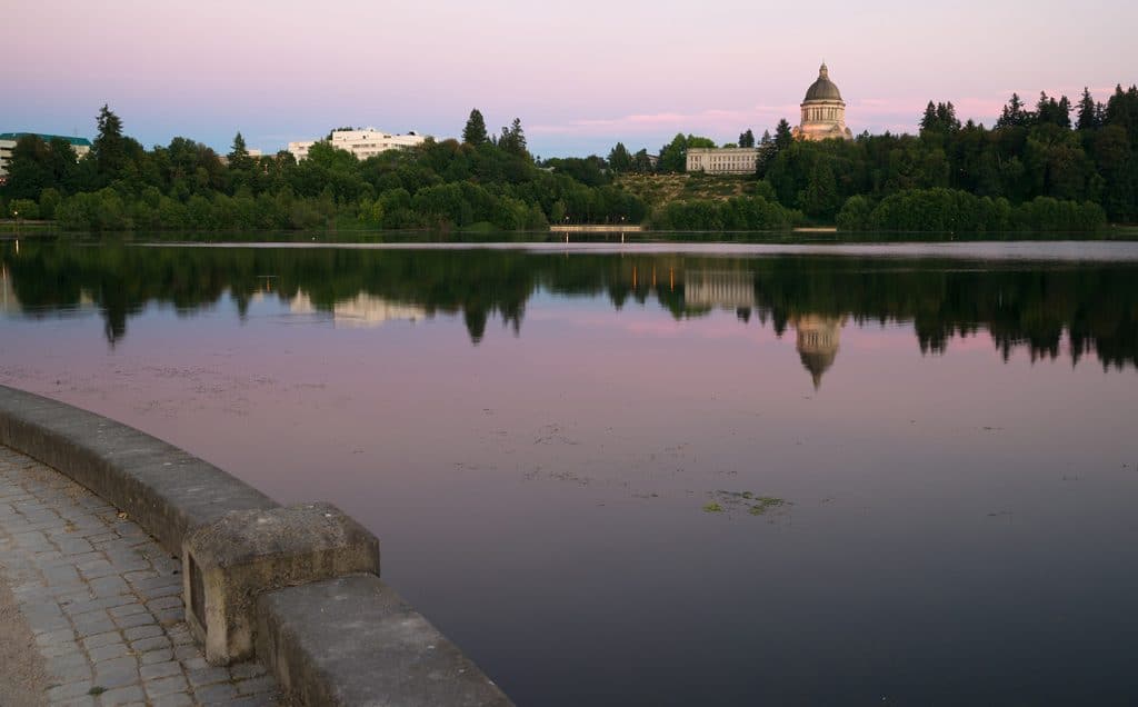 The state capital reflects in the lake of the same name at dusk in Olympia Wa