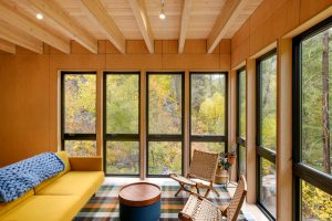 Maple plywood frames windows, revealing river and canyon views.
