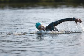Open water swimmers wear bright caps to be seen by other water users.