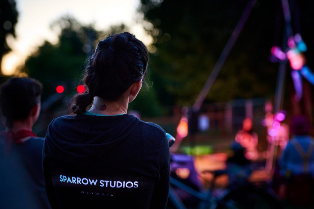 Naomi watches aerial performances in the park. Sparrow Studios is one of two aerialist studios in Olympia.