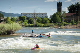 Kayakers play on Brennan’s Wave, a manmade playground on the Clark Fork River in Missoula.