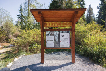 The Dog Woods sign touches on the history of the nature preserve.